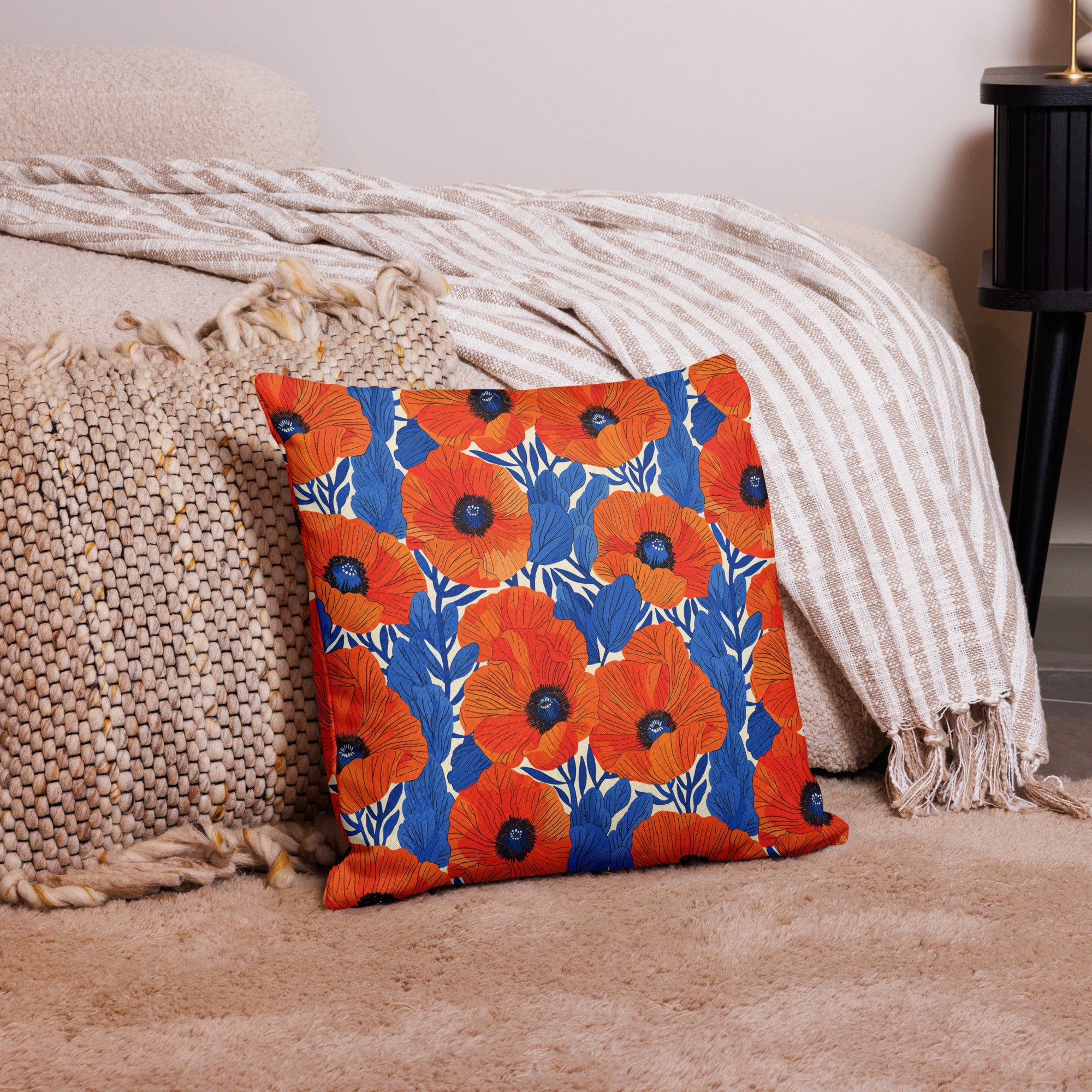 Colorful pillow with bright red and blue floral design on a soft beige background, enhancing cozy home decor.