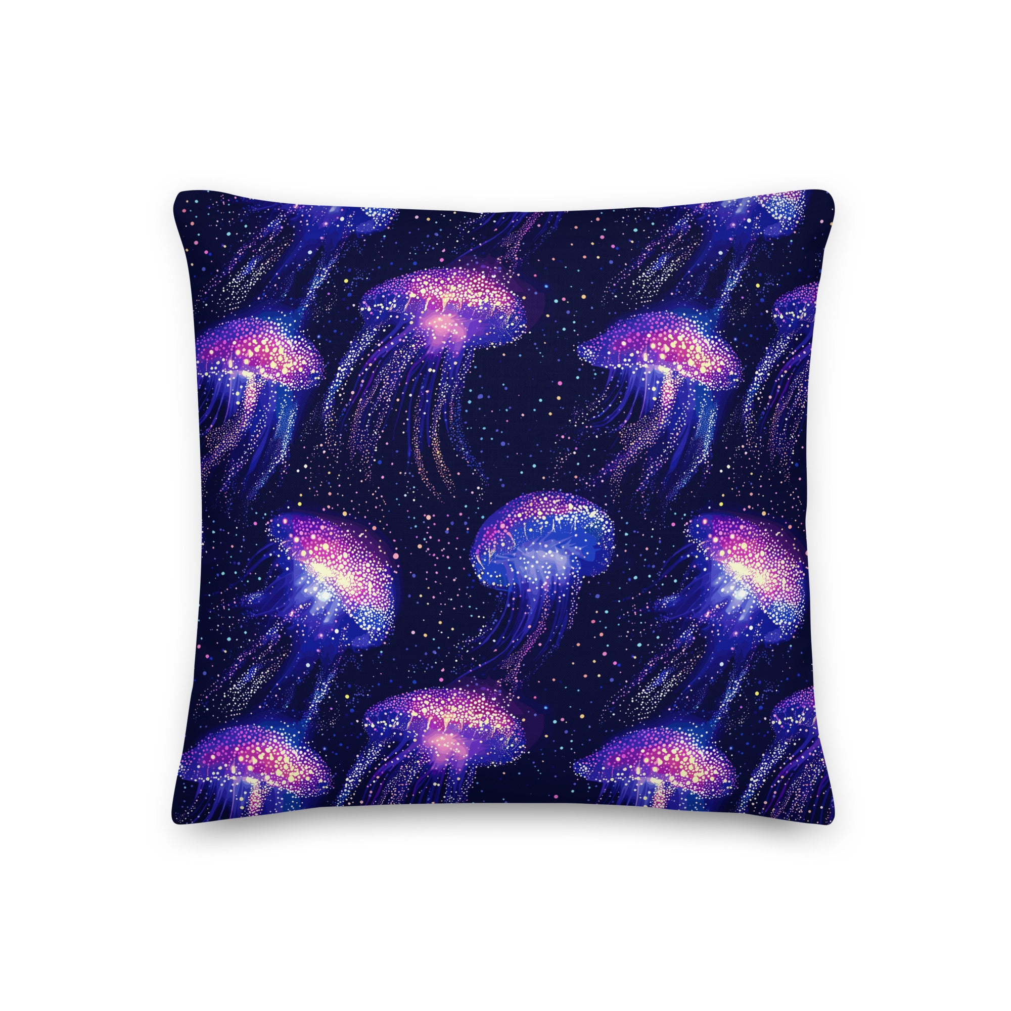 Knitted pillow featuring vibrant jellyfish design in iridescent purple and pink on a midnight blue background.