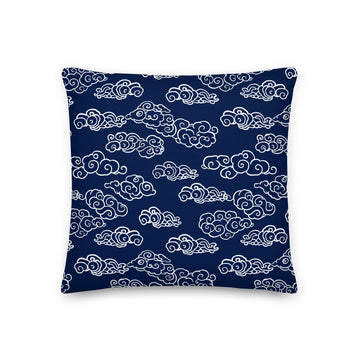 Navy knitted pillow with intricate white cloud pattern, perfect for winter decor.