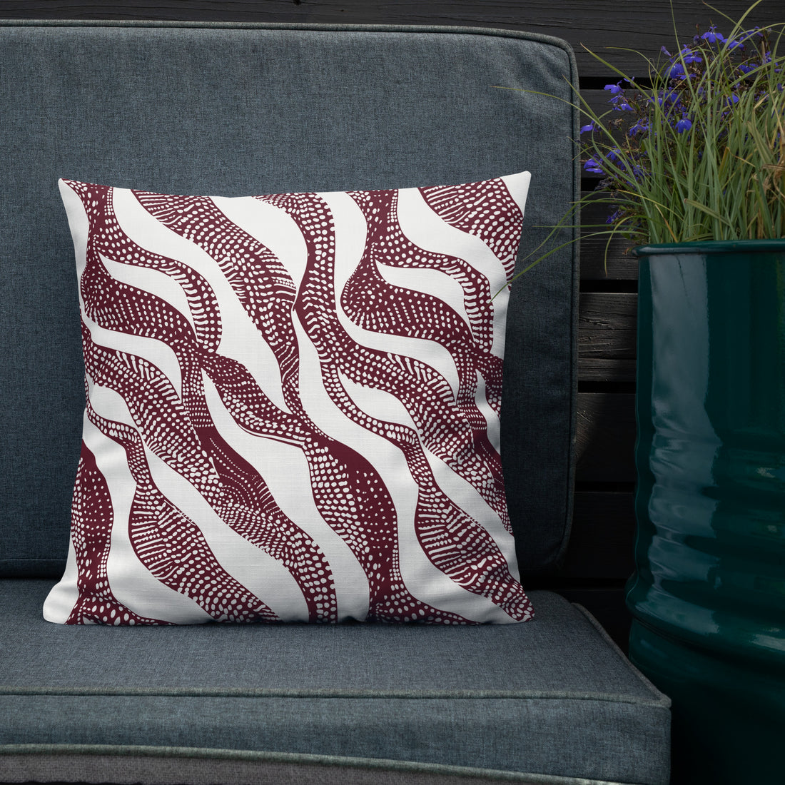 Decorative luxury knit pillow with a burgundy wave pattern, perfect for winter and holiday décor.