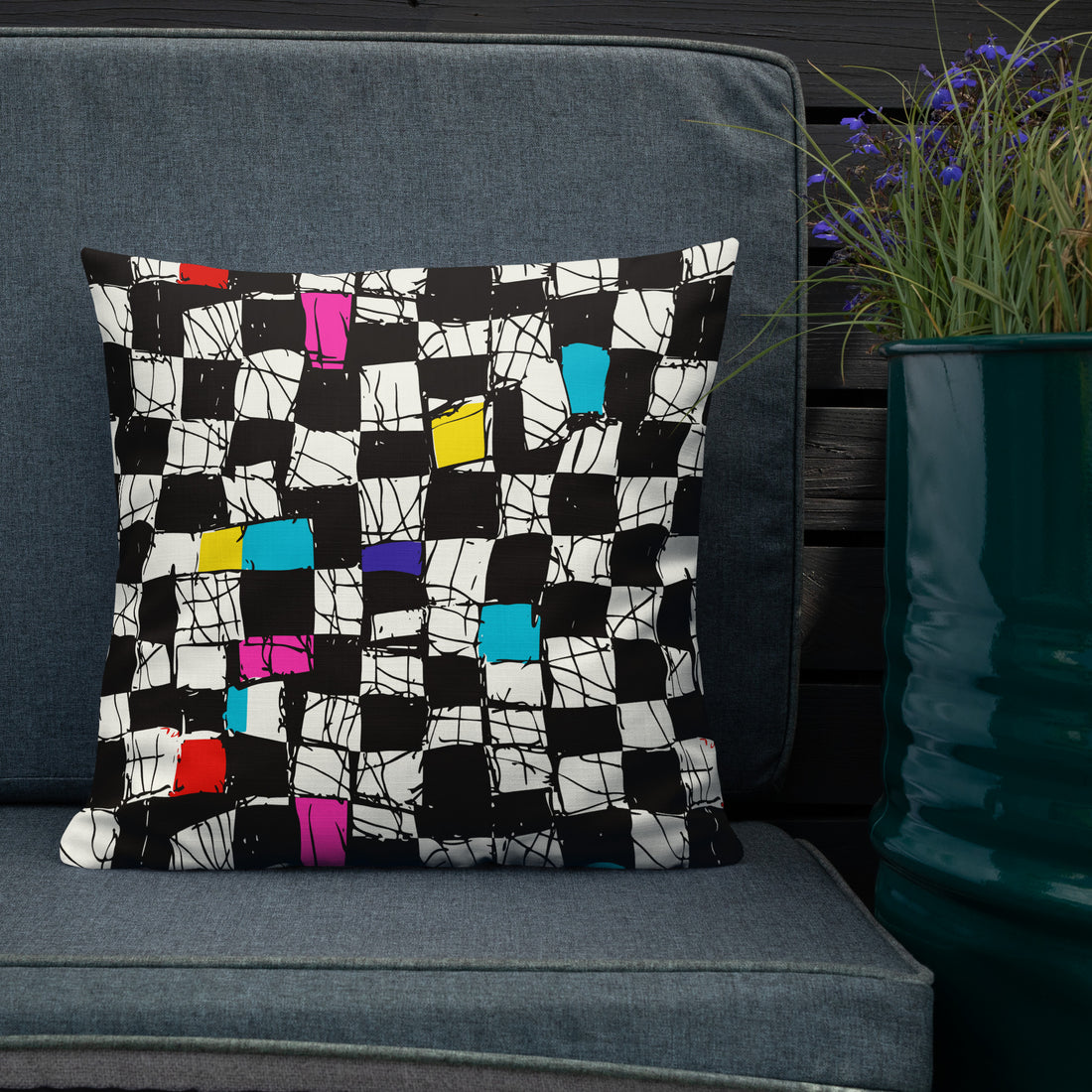 Vibrant Abstract Checkered Pillow with Red, Yellow, Blue, and Purple Squares on Black and White Background