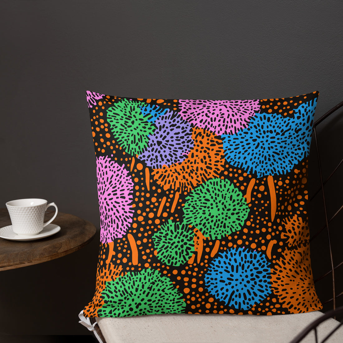 Vibrant premium pillow with colorful abstract pattern on a black background, featuring greens, pinks, blues, and oranges. Perfect for home decor.