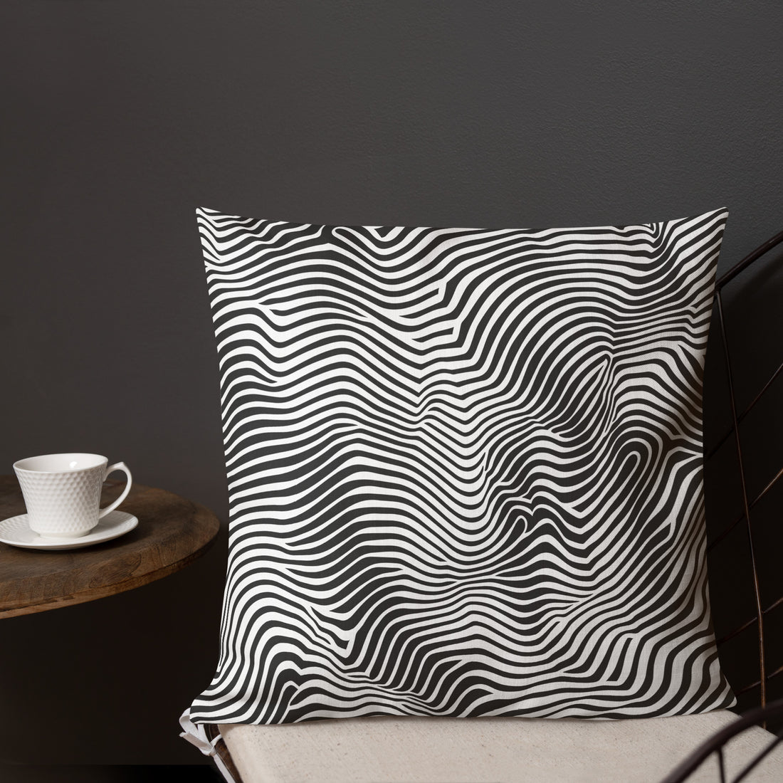 Modern black and white wave design pillow on a home décor setting.