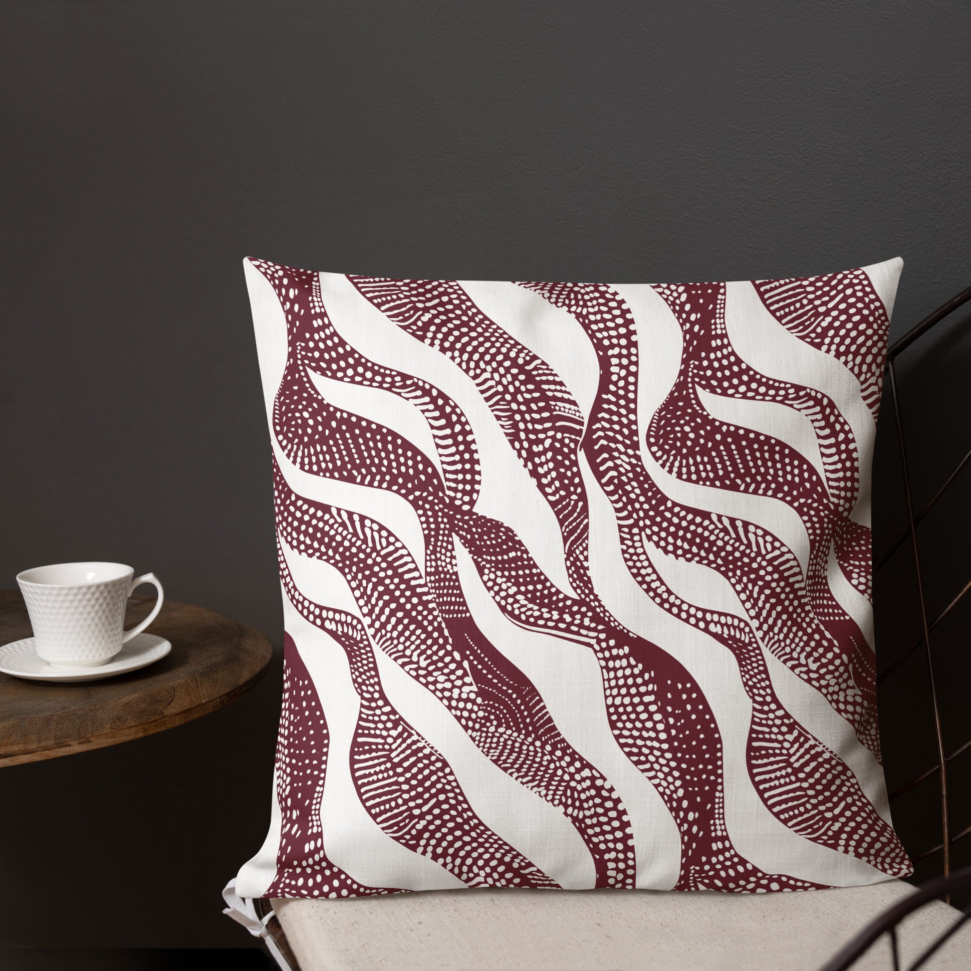 Decorative luxury knit pillow with a burgundy wave pattern, perfect for winter and holiday décor.