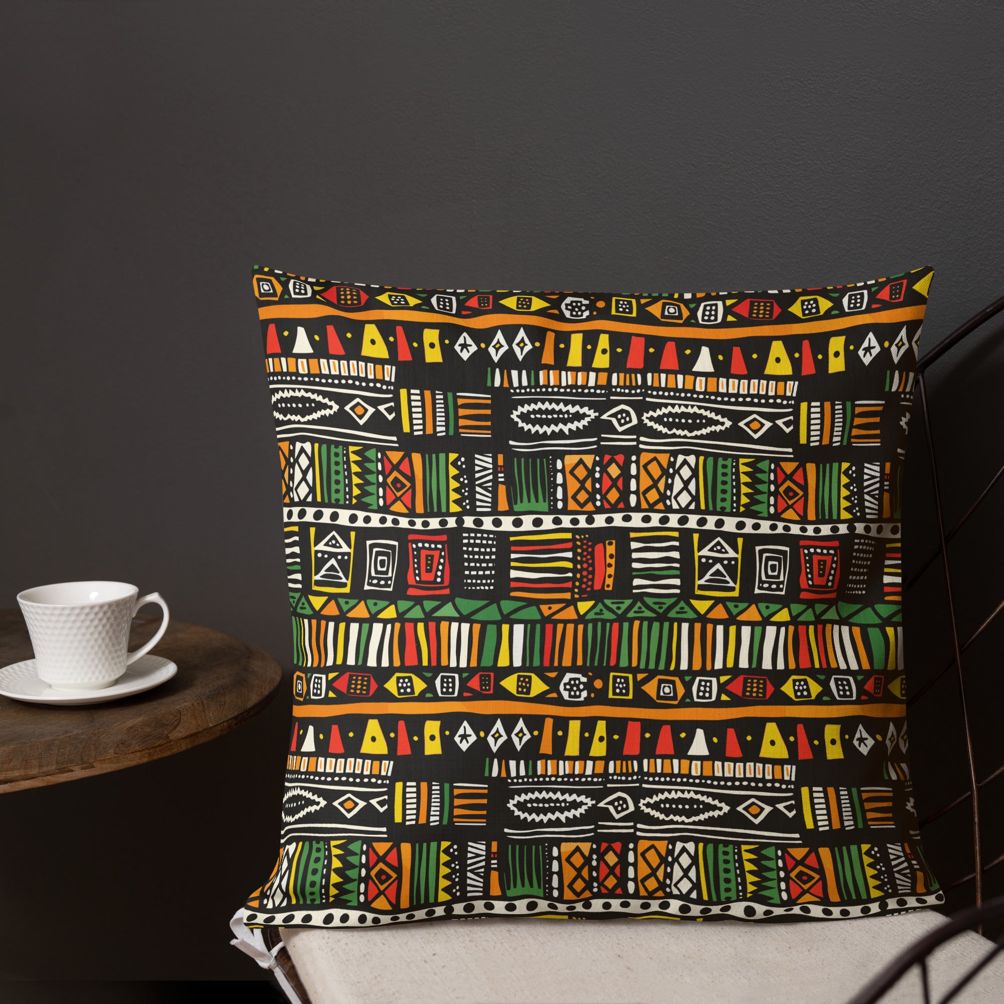 Pillow with vibrant tribal pattern in red, orange, green, and yellow, perfect for holiday decor.