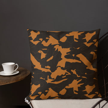 Square pillow with an abstract golden camo design, featuring a hidden zipper, against a neutral background.