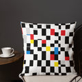 A cushion with a Mondrian-inspired design featuring vibrant geometric blocks in black, red, yellow, and blue, bringing a modern and festive touch to any room.