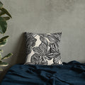 Black and white tropical leaf pattern on a knitted pillow. Modern home decor with a comfy, fabric.