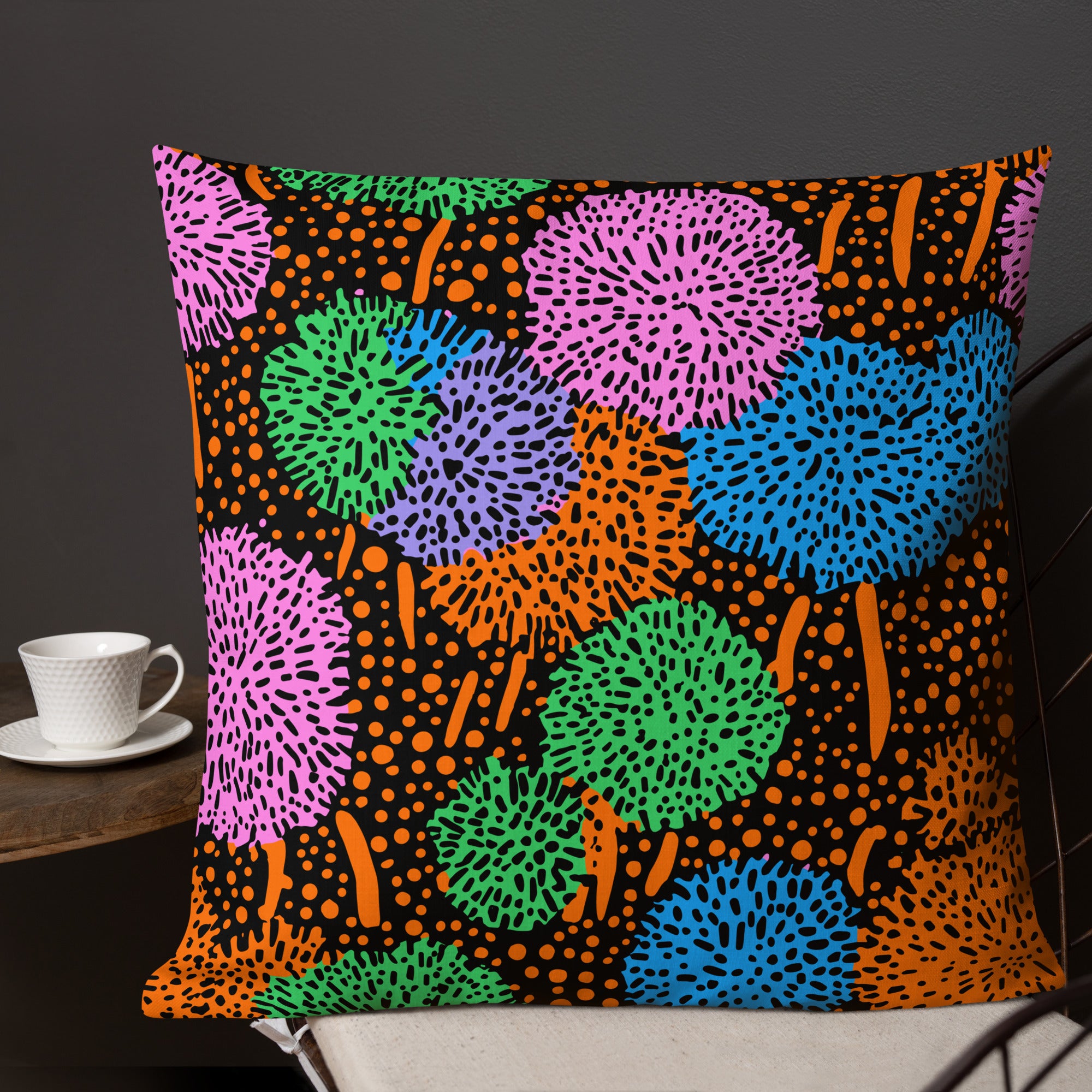 Vibrant premium pillow with colorful abstract pattern on a black background, featuring greens, pinks, blues, and oranges. Perfect for home decor.