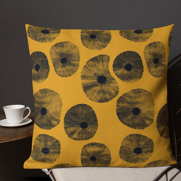 Vibrant floral print premium pillow in mustard with black flowers.