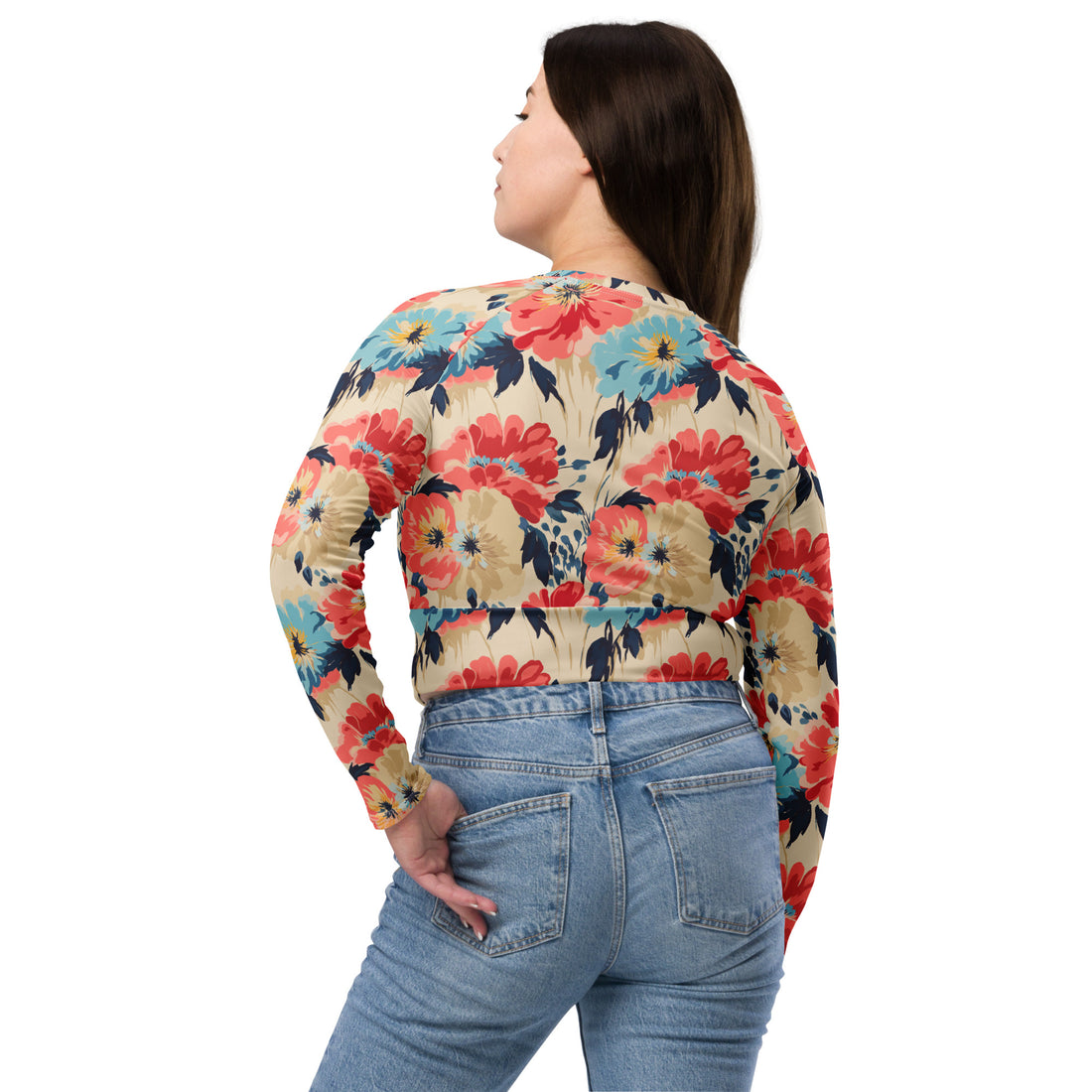 Model wearing a long-sleeve crop top with vibrant red and blue floral design on a beige background, suitable for winter fashion.