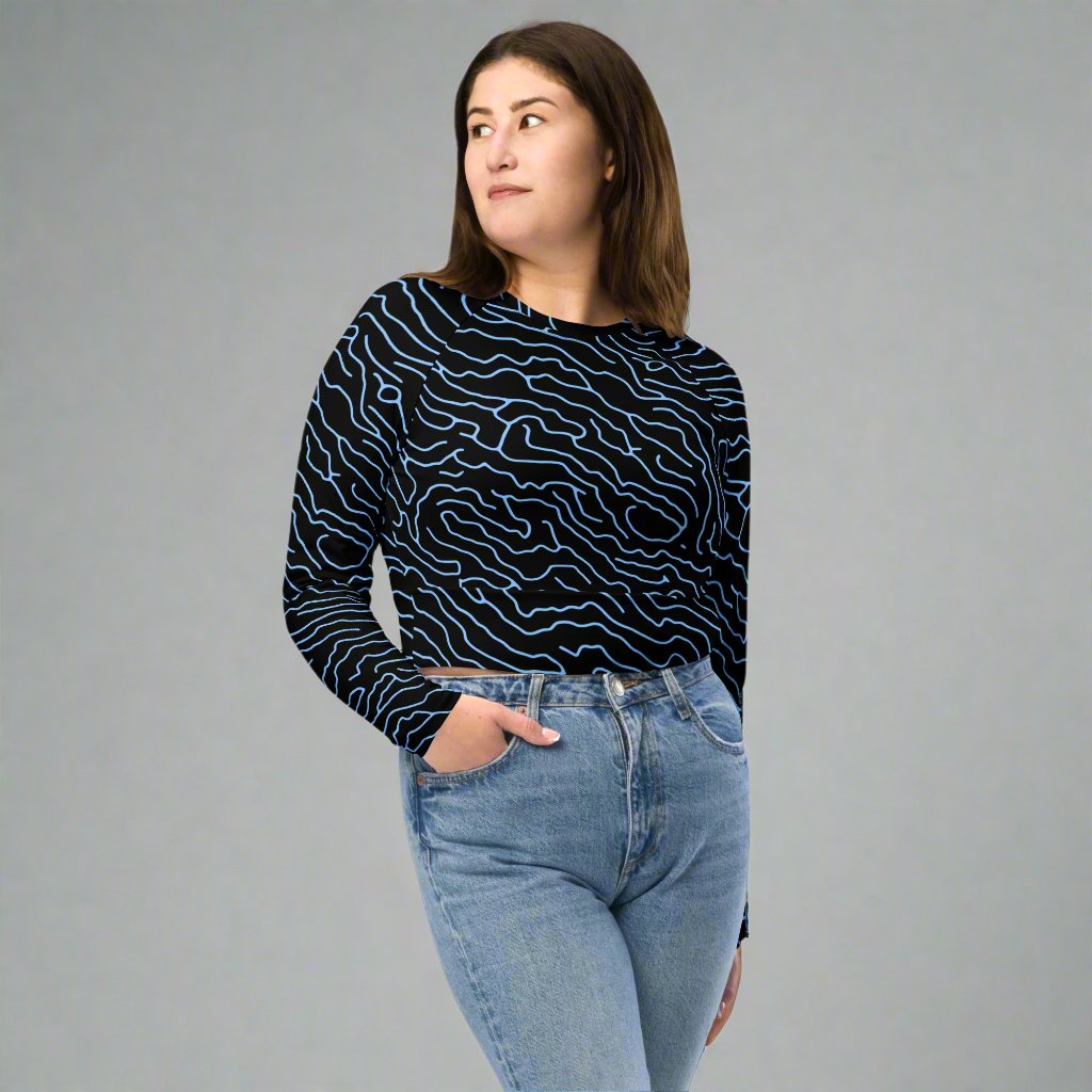 Black long-sleeve crop top with blue wavy pattern, showcasing a modern and trendy design.