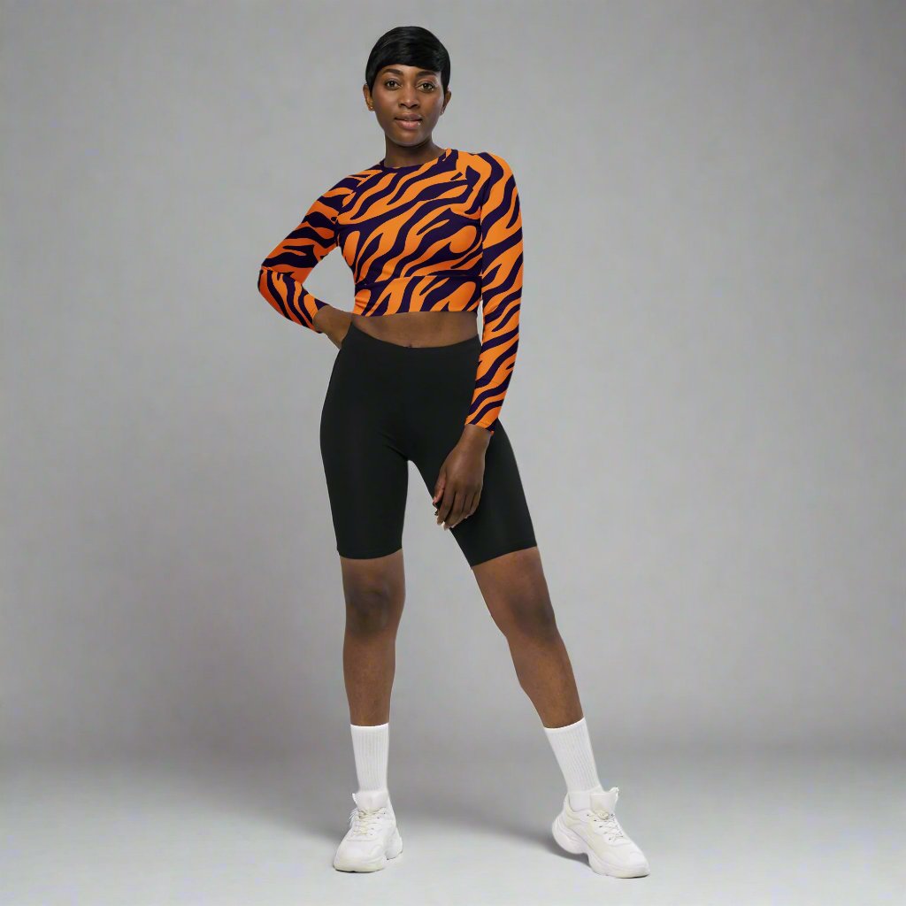 Model wearing an eco-friendly long-sleeve crop top with a tiger stripe design, showcasing a stylish and trendy look.