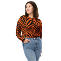 Model wearing an eco-friendly long-sleeve crop top with a bold zebra print in orange and black.