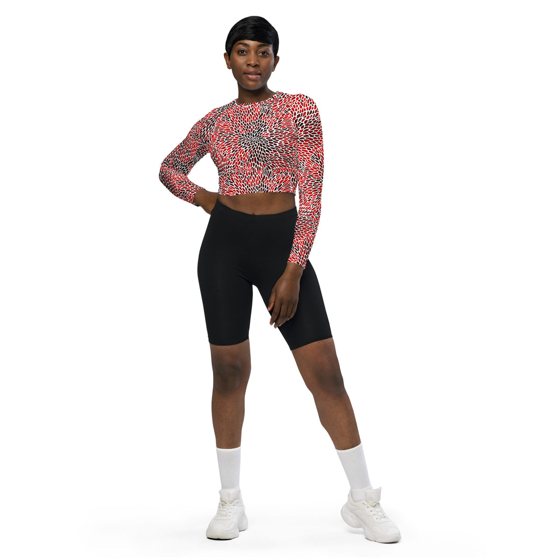 Model wearing eco-friendly recycled long-sleeve crop top in a vibrant red pattern.