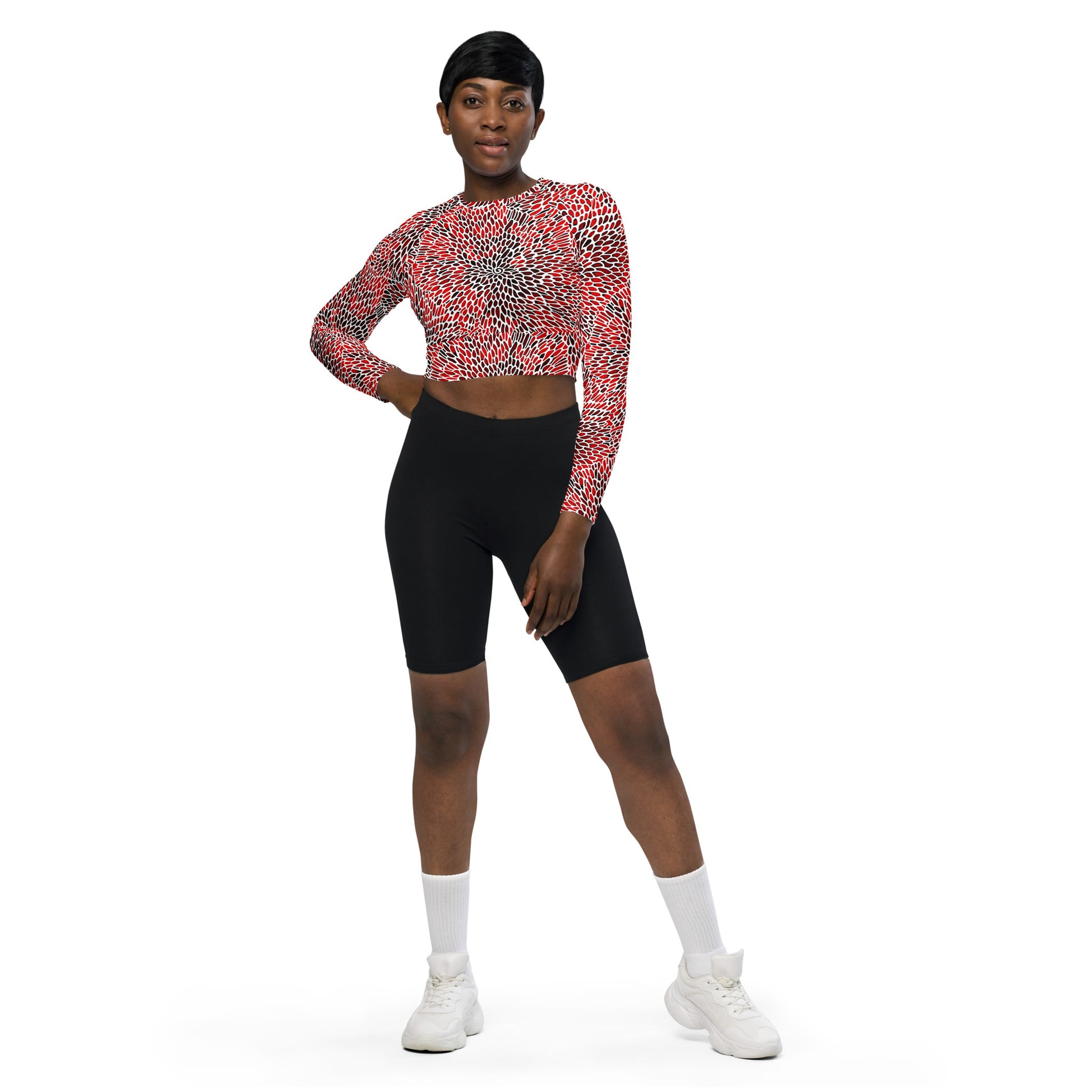 Model wearing eco-friendly recycled long-sleeve crop top in a vibrant red pattern.