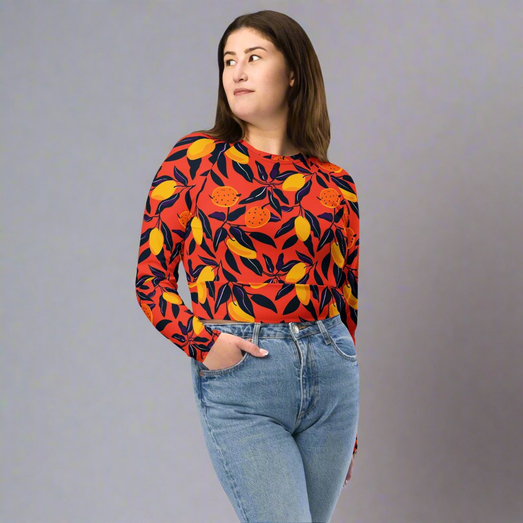 Eco-friendly long-sleeve crop top featuring vibrant floral design in red, yellow, and orange hues.