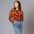 Eco-friendly long-sleeve crop top featuring vibrant floral design in red, yellow, and orange hues.