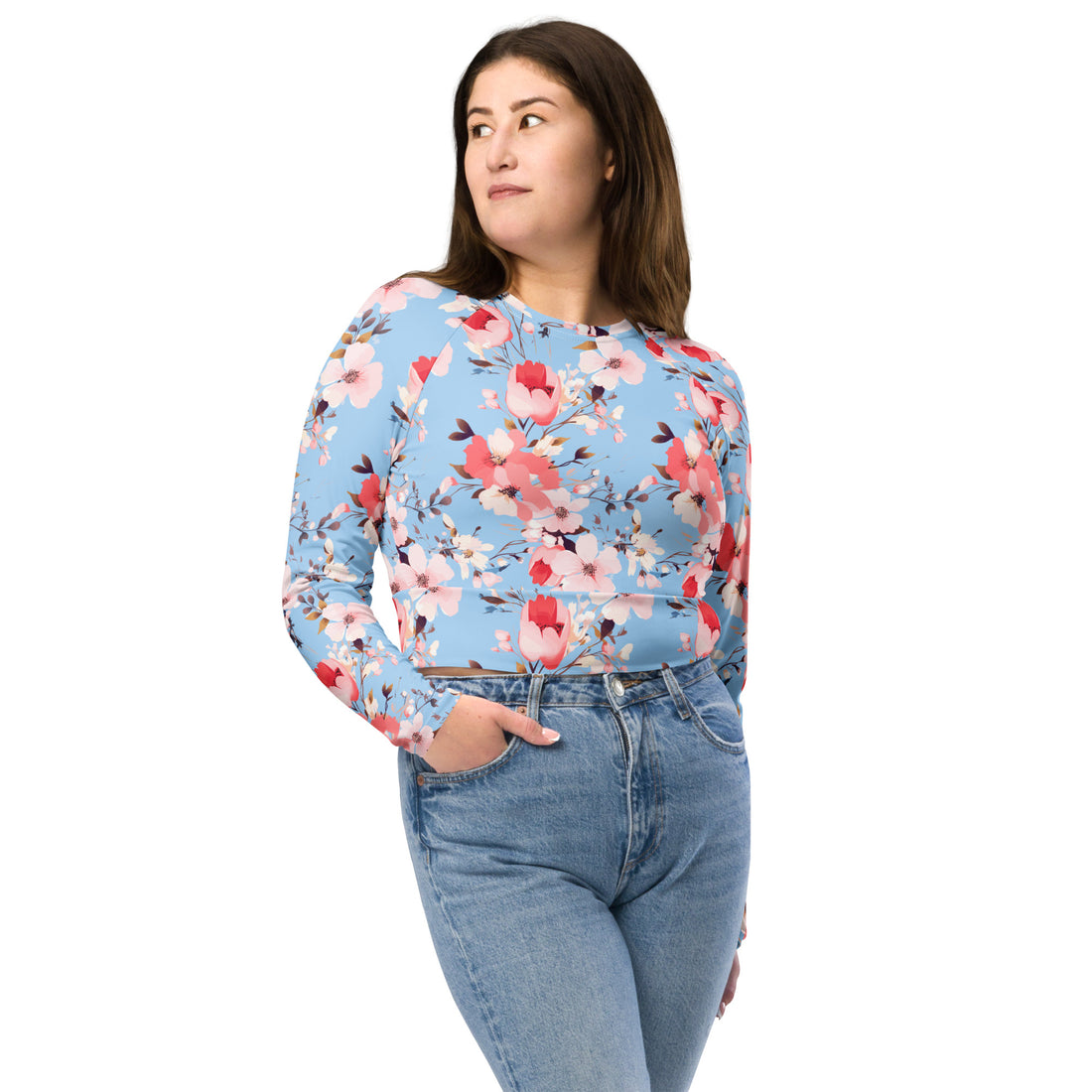 Vibrant floral crop top featuring pink and red blossoms on a blue background, long sleeves, perfect for winter fashion.