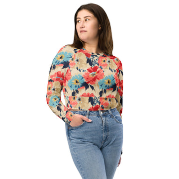 Model wearing a long-sleeve crop top with vibrant red and blue floral design on a beige background, suitable for winter fashion.