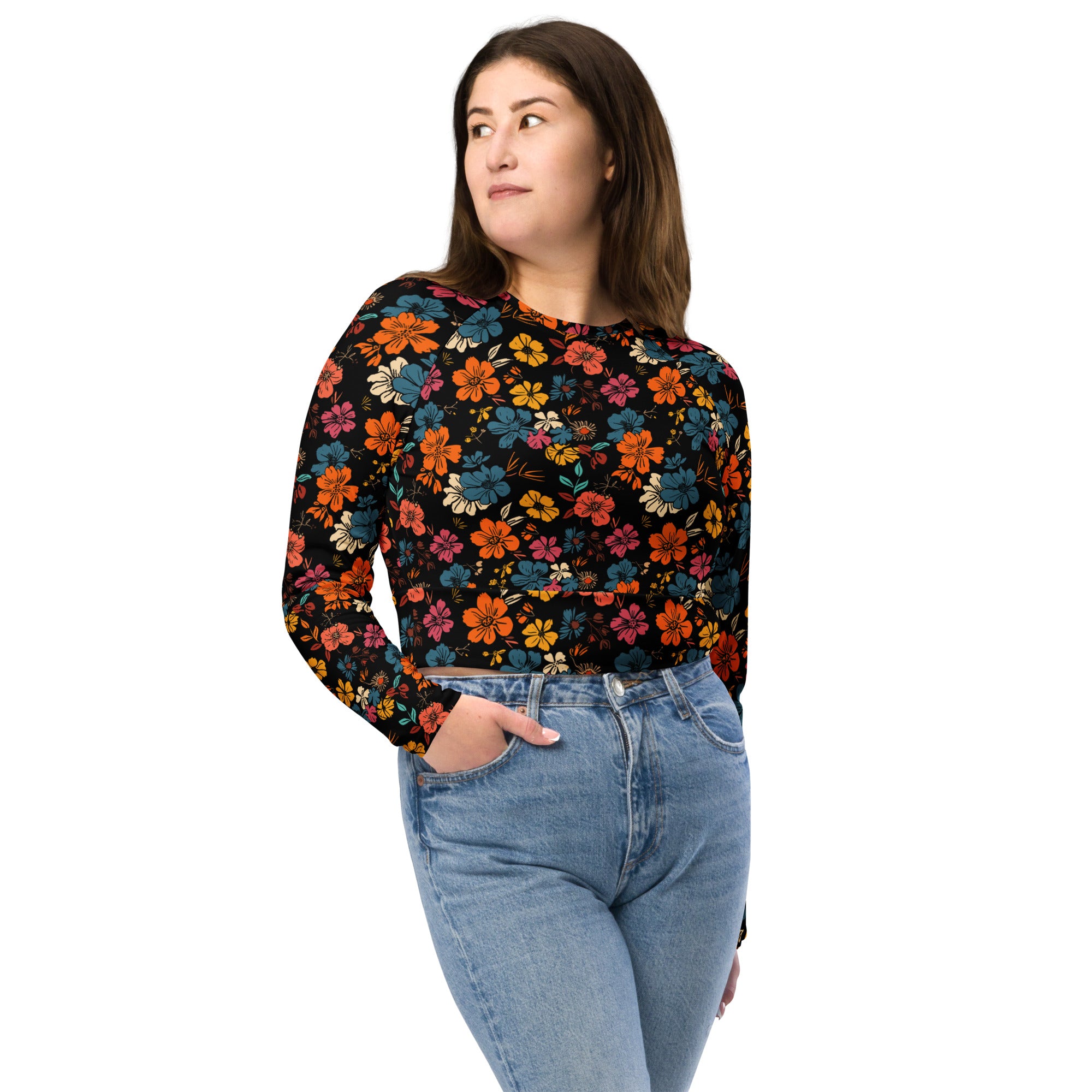 Eco-friendly long-sleeve crop top with vibrant floral design in orange, teal, and pink on a black background, perfect for winter fashion.