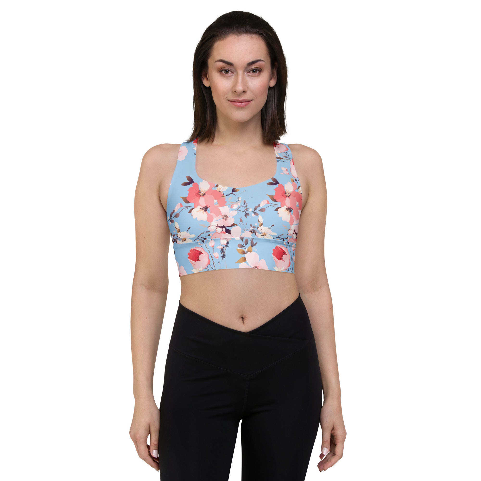 Women's winter floral sports bra with vibrant red and pink poppy blossoms on a blue background, eco-friendly design.