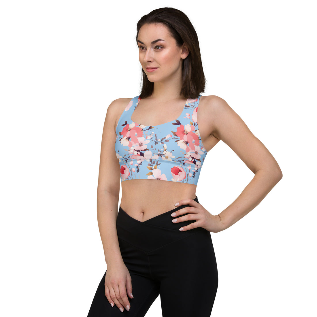 Women's winter floral sports bra with vibrant red and pink poppy blossoms on a blue background, eco-friendly design.