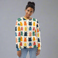 Women's sweatshirt featuring playful Halloween monster design, showcasing colorful cartoon monsters on a light background.