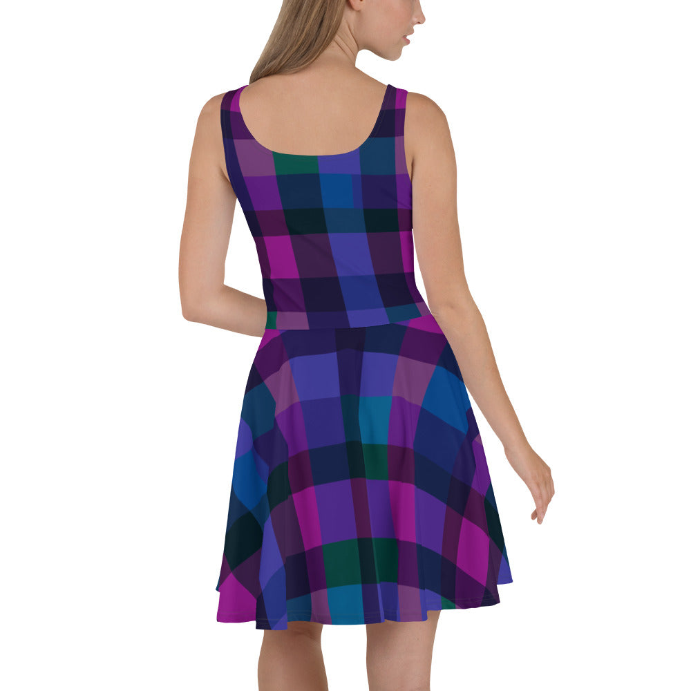 A model wearing a vibrant skater dress with a colorful tartan pattern in purple and teal.