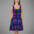 A model wearing a vibrant skater dress with a colorful tartan pattern in purple and teal.