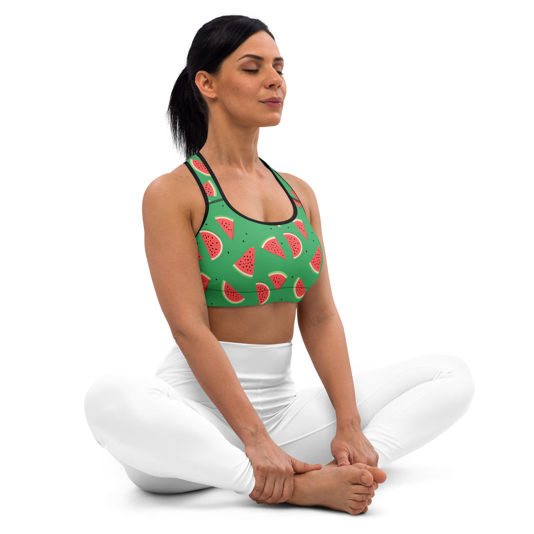 Woman wearing a vibrant green sports bra with watermelon print, striking a yoga pose.