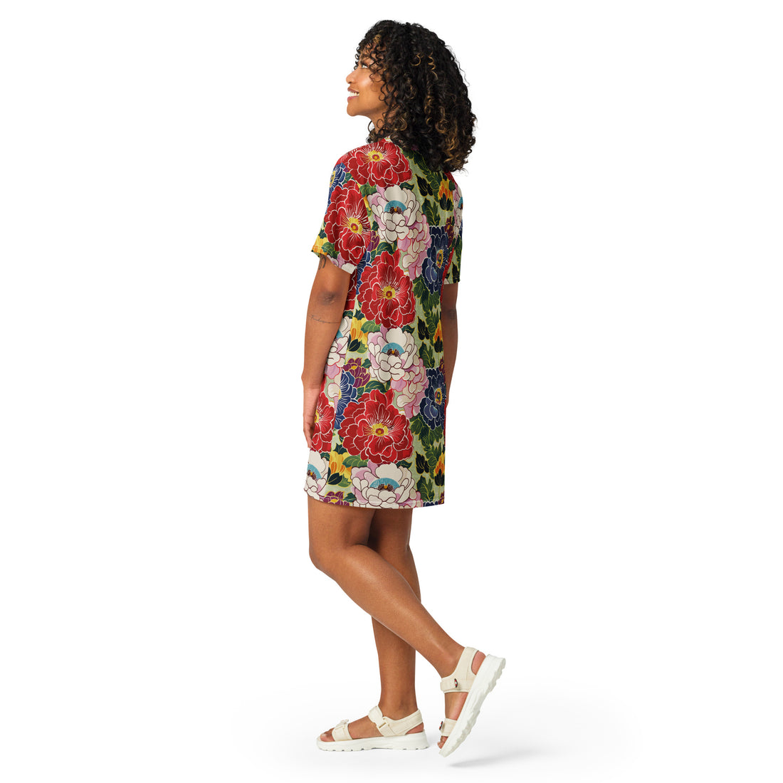 Model wearing a floral oversized T-shirt dress featuring vibrant colors and patterns.