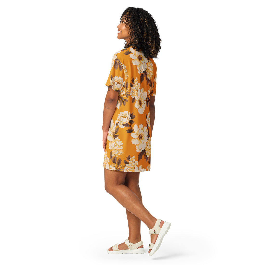 Model wearing a floral oversized T-shirt dress in warm golden hues