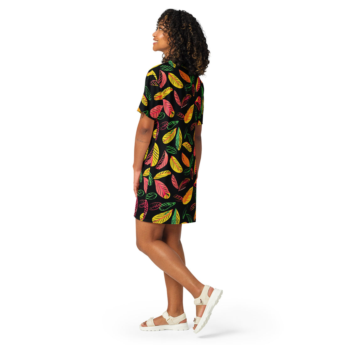 Vibrant leaf print t-shirt dress featuring colorful leaves on a black background, perfect for versatile styling.