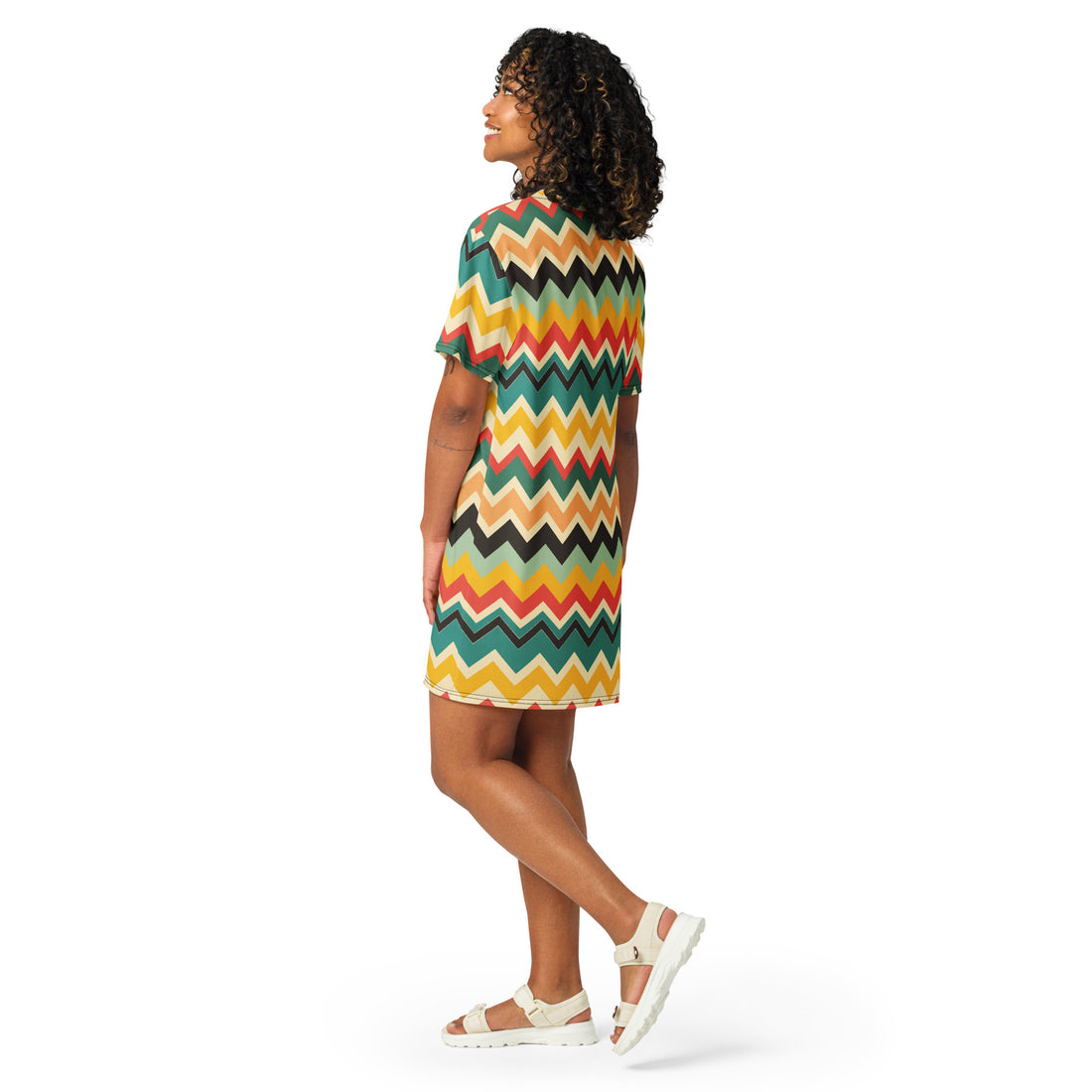 A model wearing a vibrant bohemian zigzag t-shirt dress with colorful chevron patterns.