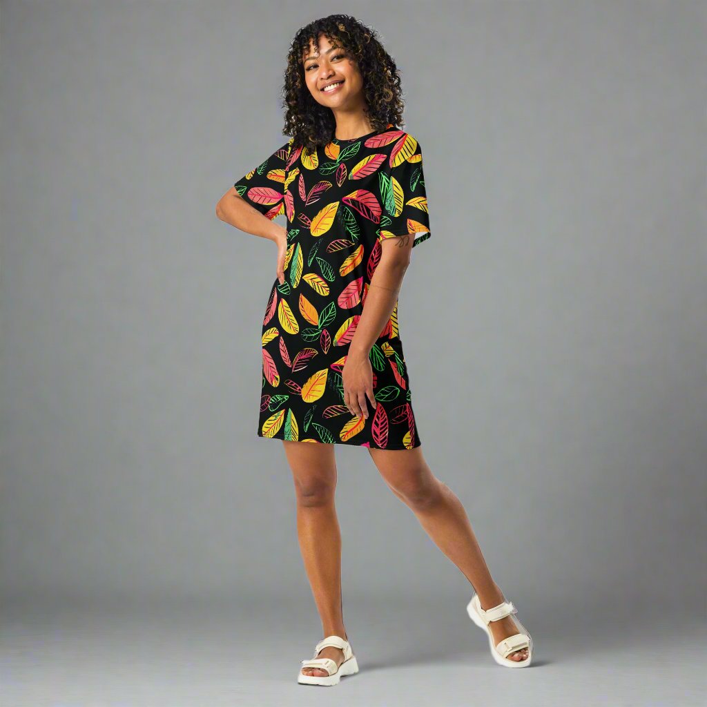 Vibrant leaf print t-shirt dress featuring colorful leaves on a black background, perfect for versatile styling.