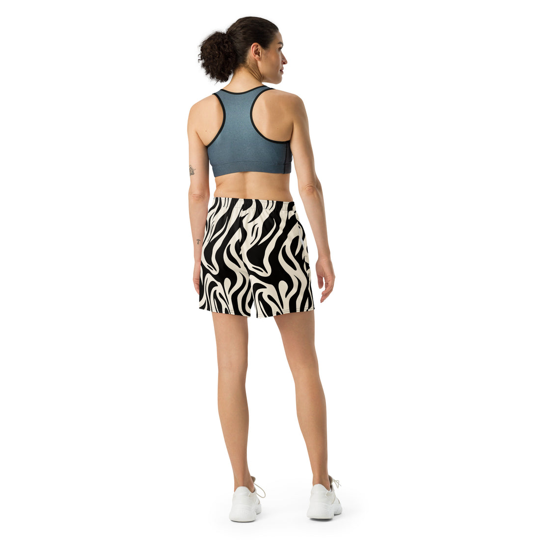 Zebra print unisex athletic long shorts displayed on a model, featuring a breathable design for active lifestyles.