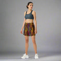 Vibrant unisex athletic long shorts in striped pattern worn by a model.