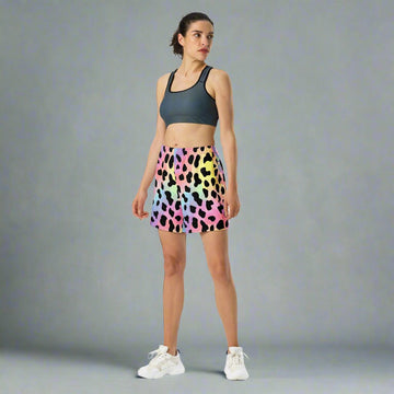 Vibrant leopard print long athletic shorts in multicolor pattern, model showcasing casual athletic wear.