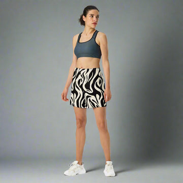 Zebra print unisex athletic long shorts displayed on a model, featuring a breathable design for active lifestyles.