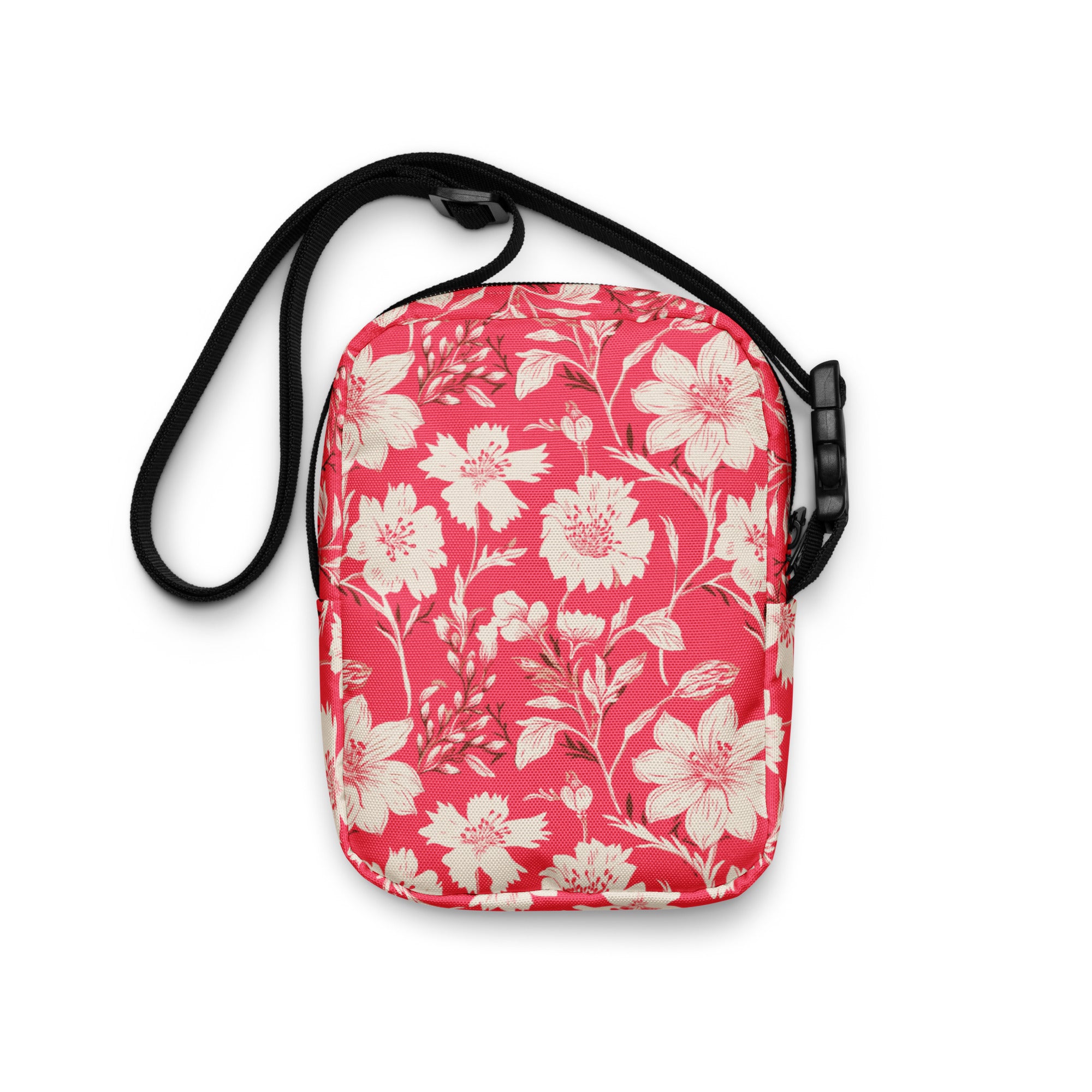 Floral utility crossbody bag with red background and white flowers.