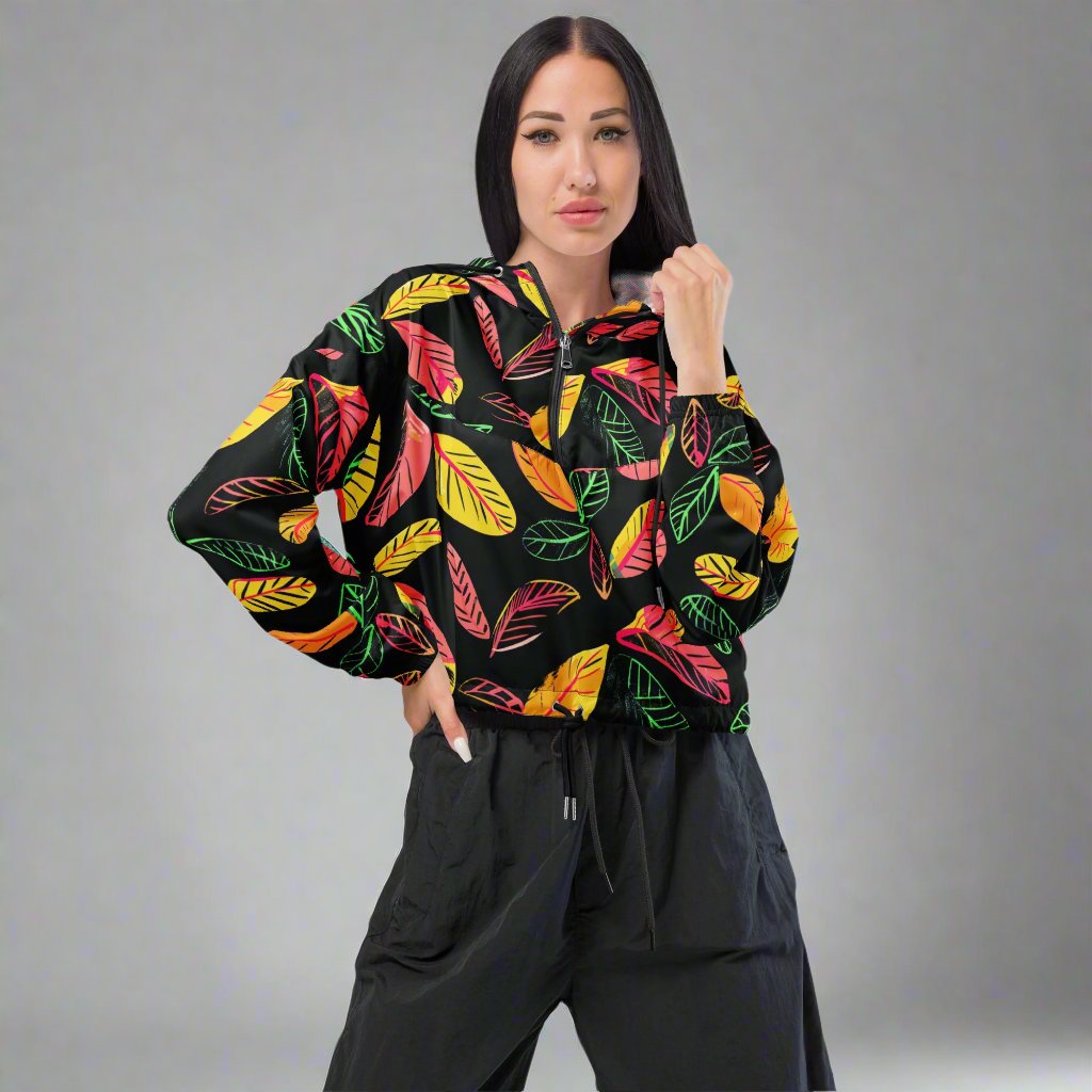 Women's cropped windbreaker featuring a colorful leaf print on a black background.