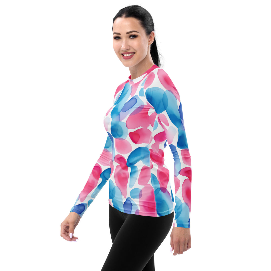 Women's long-sleeve rash guard in colorful watercolor design with pink and blue patterns.