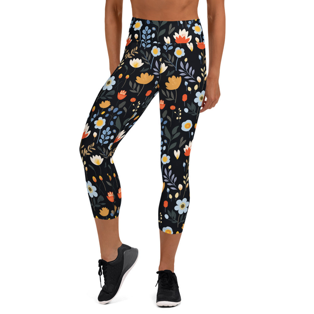 Black yoga capri leggings with vibrant autumn floral designs, featuring red, orange, and blue flowers against a dark backdrop.