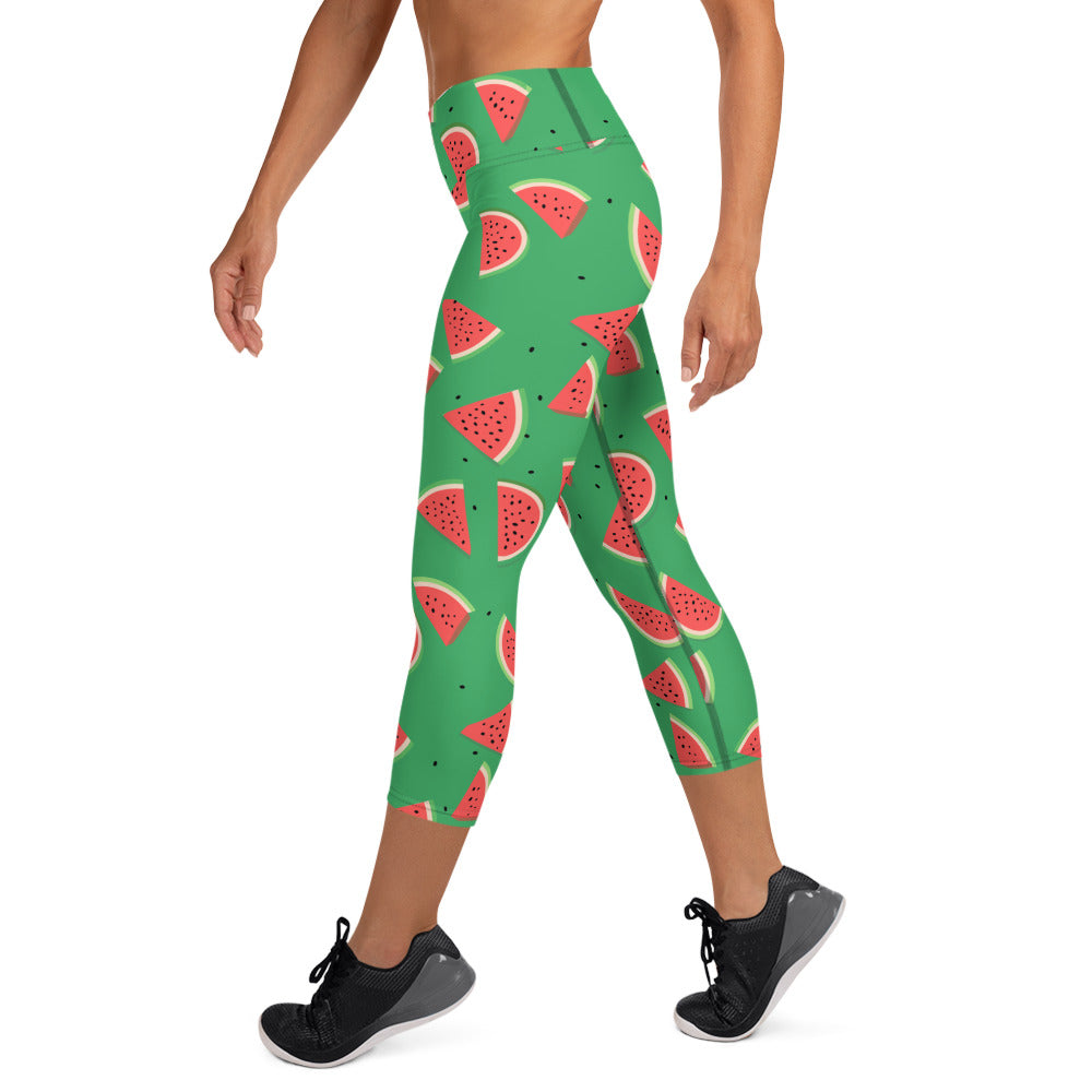 Green yoga capri leggings with playful watermelon print design highlighting the mid-calf length and comfortable high waistband.