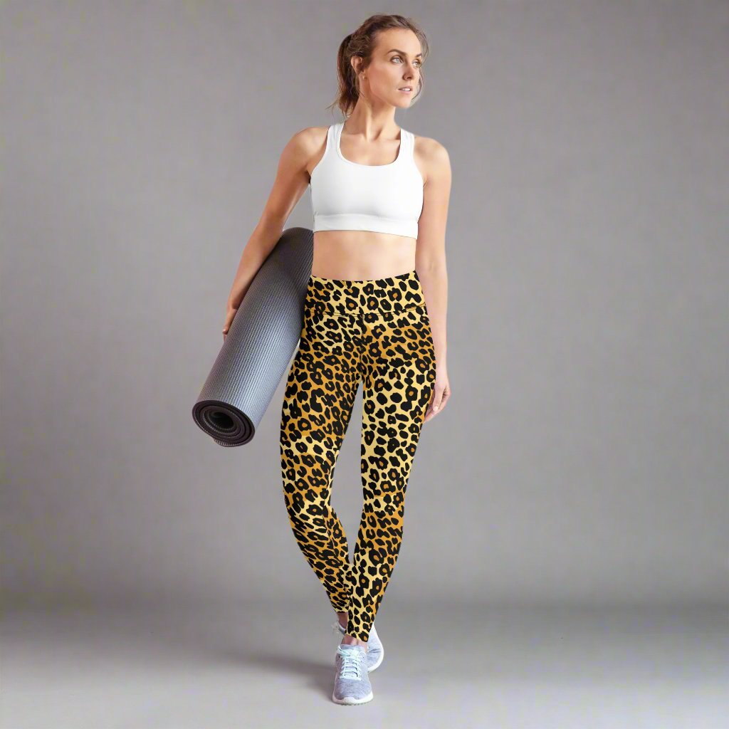 Leopard print yoga leggings with a high waistband worn by a woman holding an exercise mat.