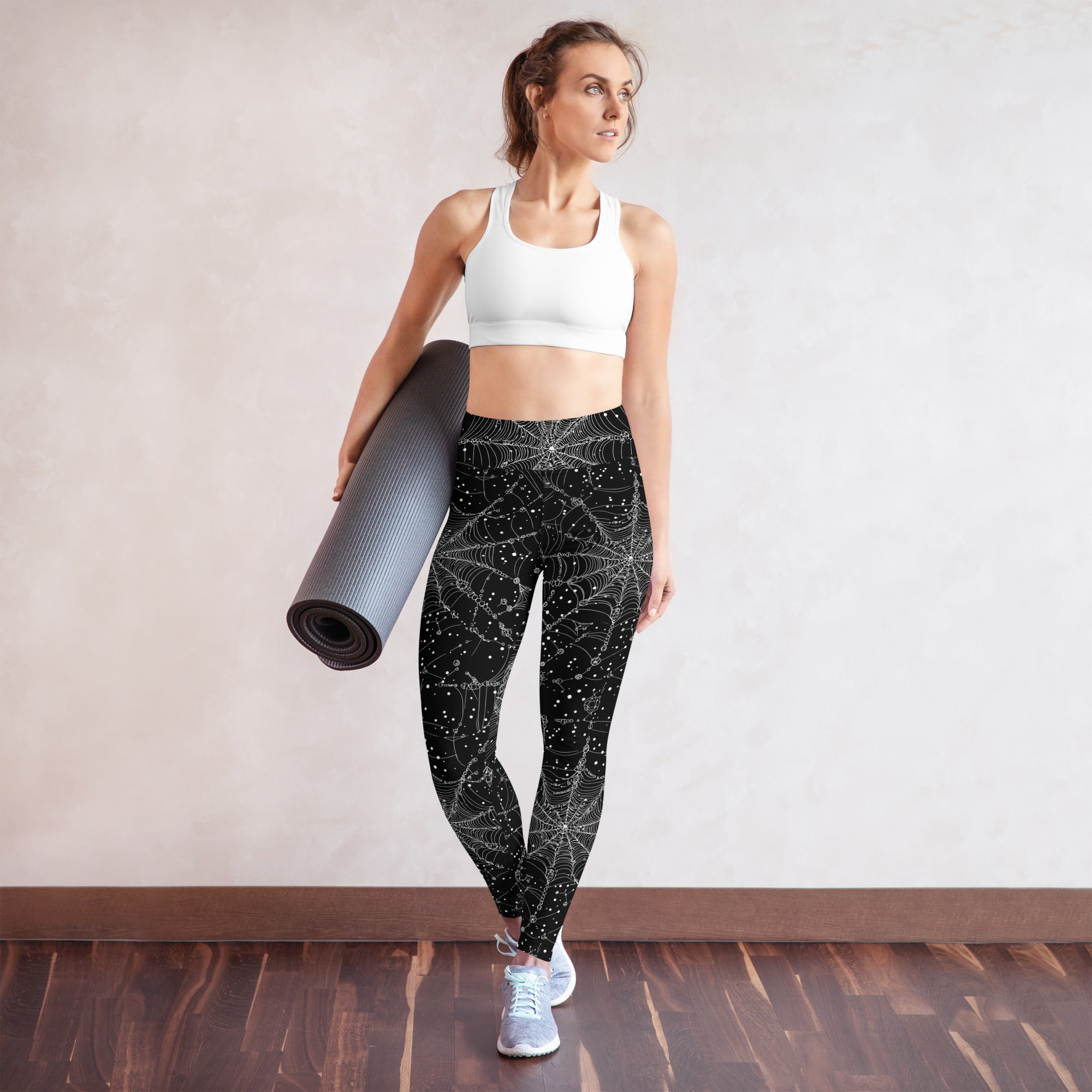 Halloween-themed yoga leggings with spiderweb design in black and white