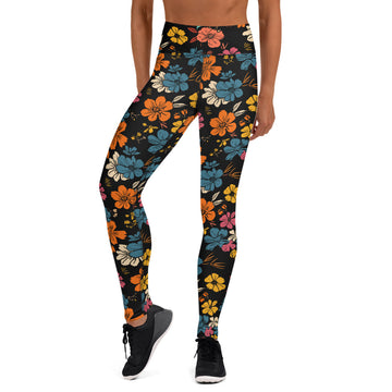 Vibrant floral yoga leggings with orange, teal, yellow, and pink flowers on a black background, displaying a raised waistband.