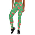 Woman wearing yoga leggings with a vibrant watermelon print on a green background, perfect for activewear and fashion-forward fitness enthusiasts.