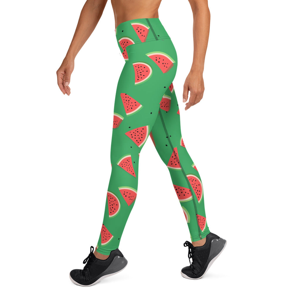 Woman wearing yoga leggings with a vibrant watermelon print on a green background, perfect for activewear and fashion-forward fitness enthusiasts.